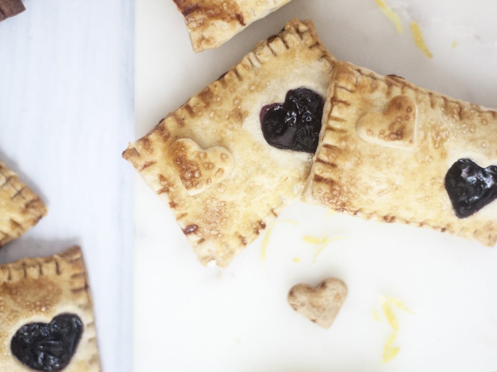 Blueberry and Lemon Hand Pies on a white background