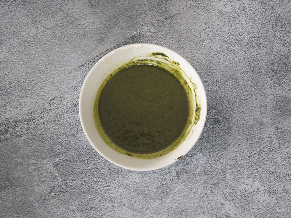 mixing matcha powder with melted butter and chocolate