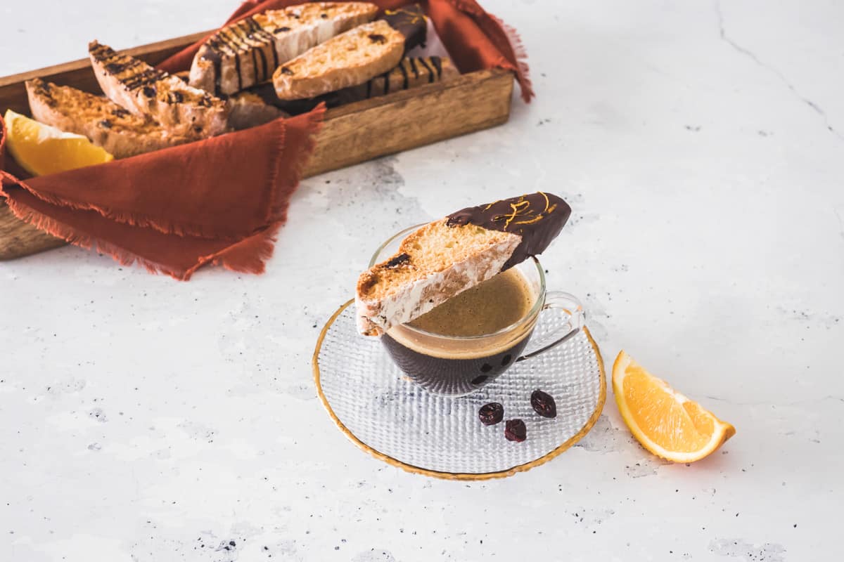 orange cranberry biscotti on a cup of coffee