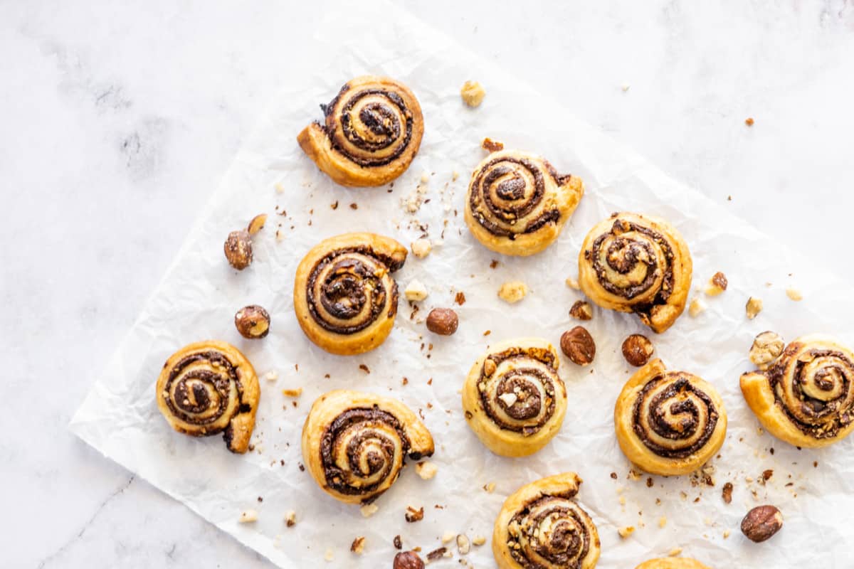 nutella pinwheels with crushed hazelnuts on parchment paper