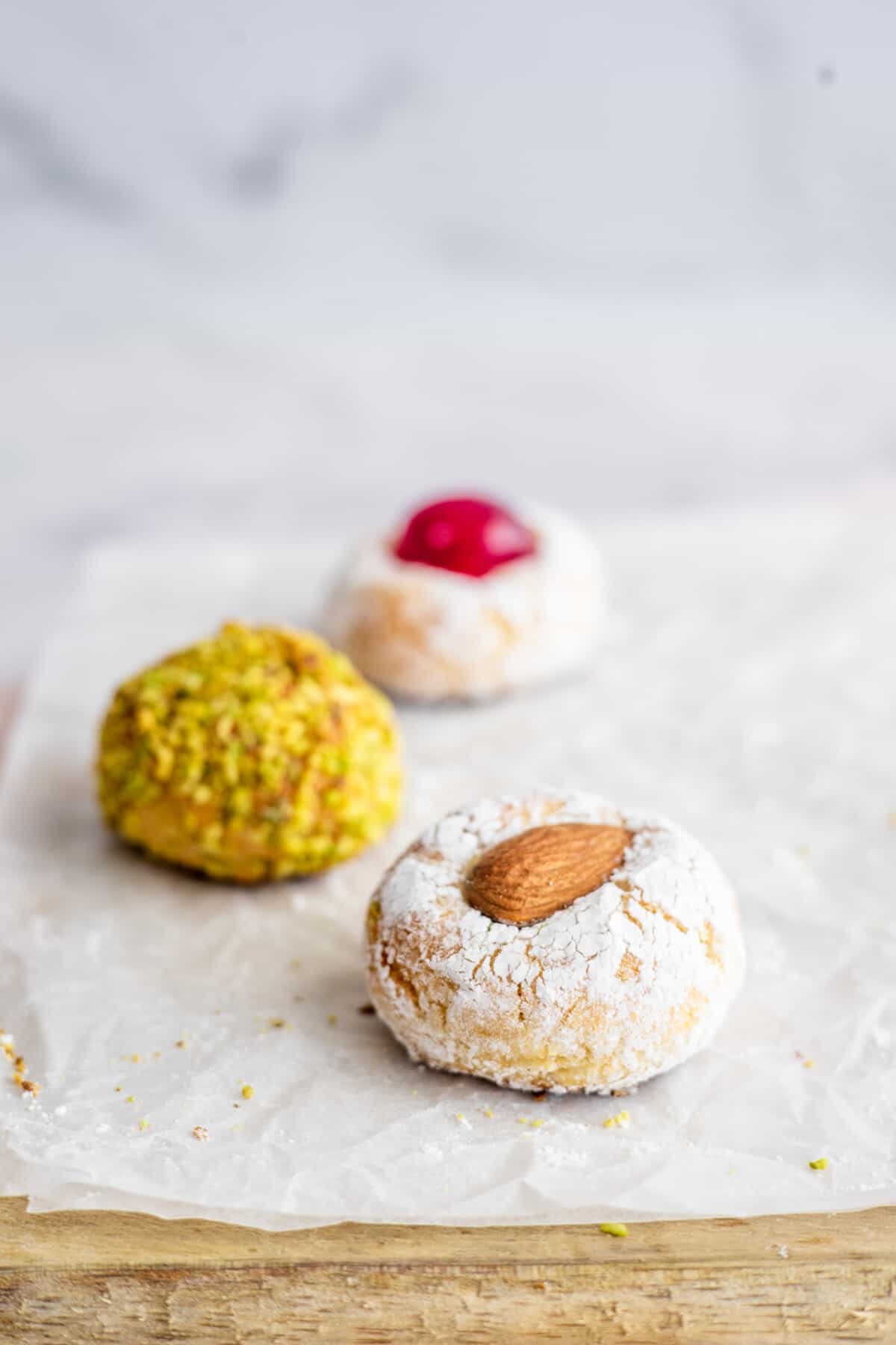 three sicilian almond cookies on a white background